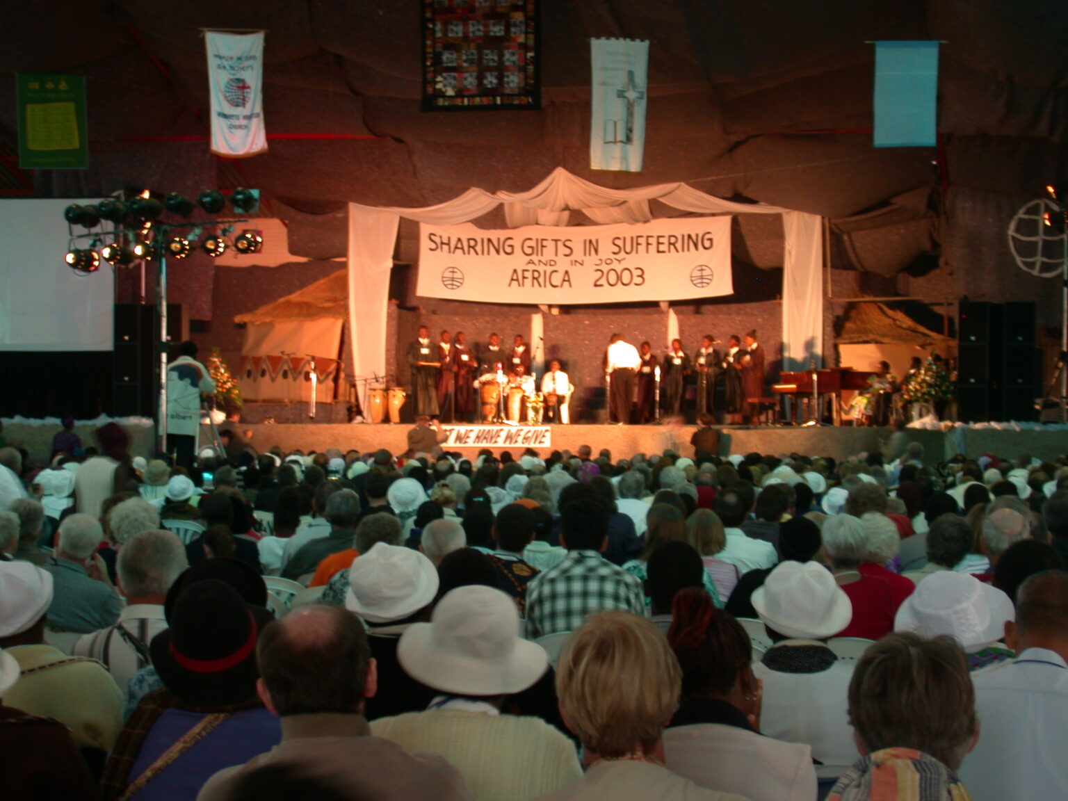 People of faith providing relief, teaching, and planting trees, symbolizing mission and God’s shalom.
