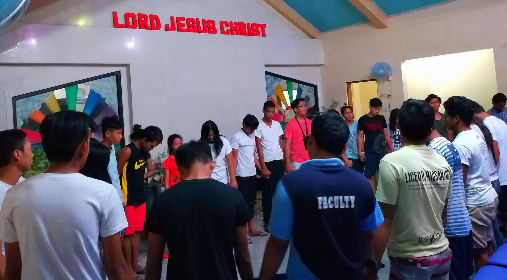 A large group of young church members gathered together outdoors at Lumban Mennonite Bible Church in the Philippines